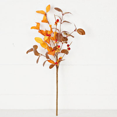 Artificial floral branch with orange and brown leaves on a white background