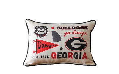 Decorative pillow with Georgia Bulldogs logo and text on a wooden surface.
